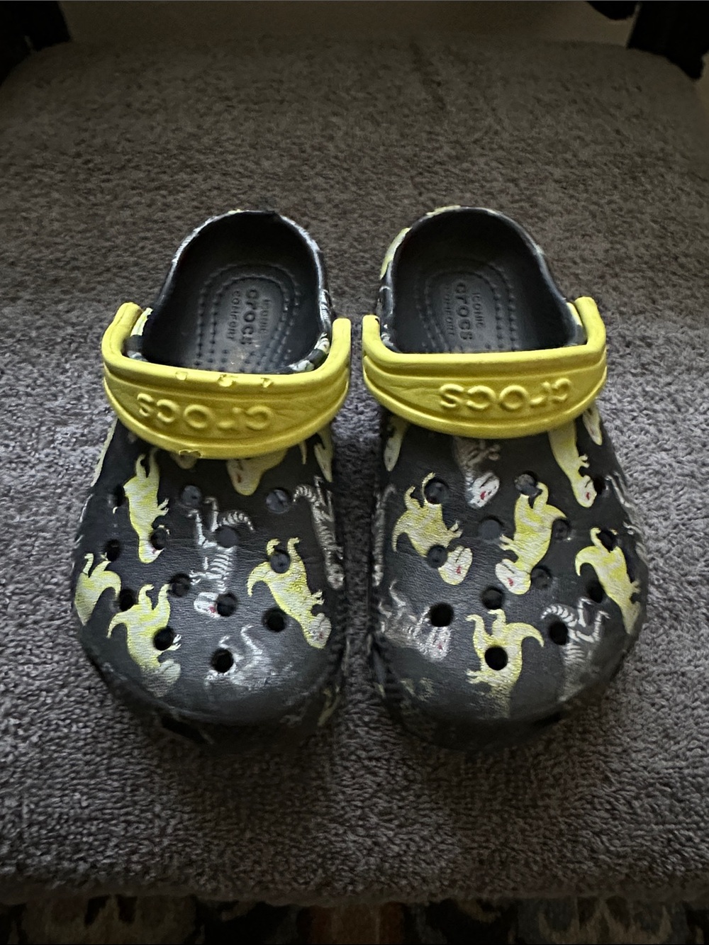 CROCS Kids Black Clogs with Yellow Ghost Print and Yellow Heel Straps